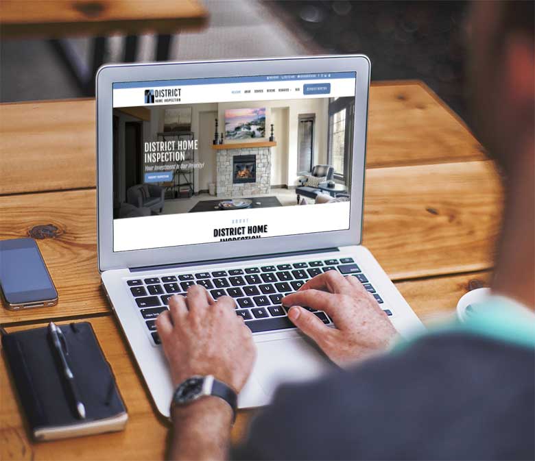 laptop on a desk showing a home inspector website